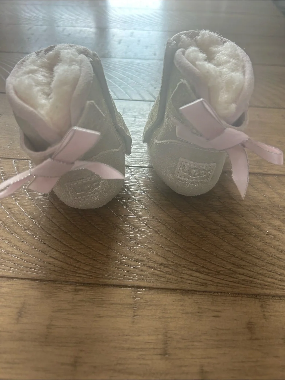 Size 0/1 UGG booties with bow